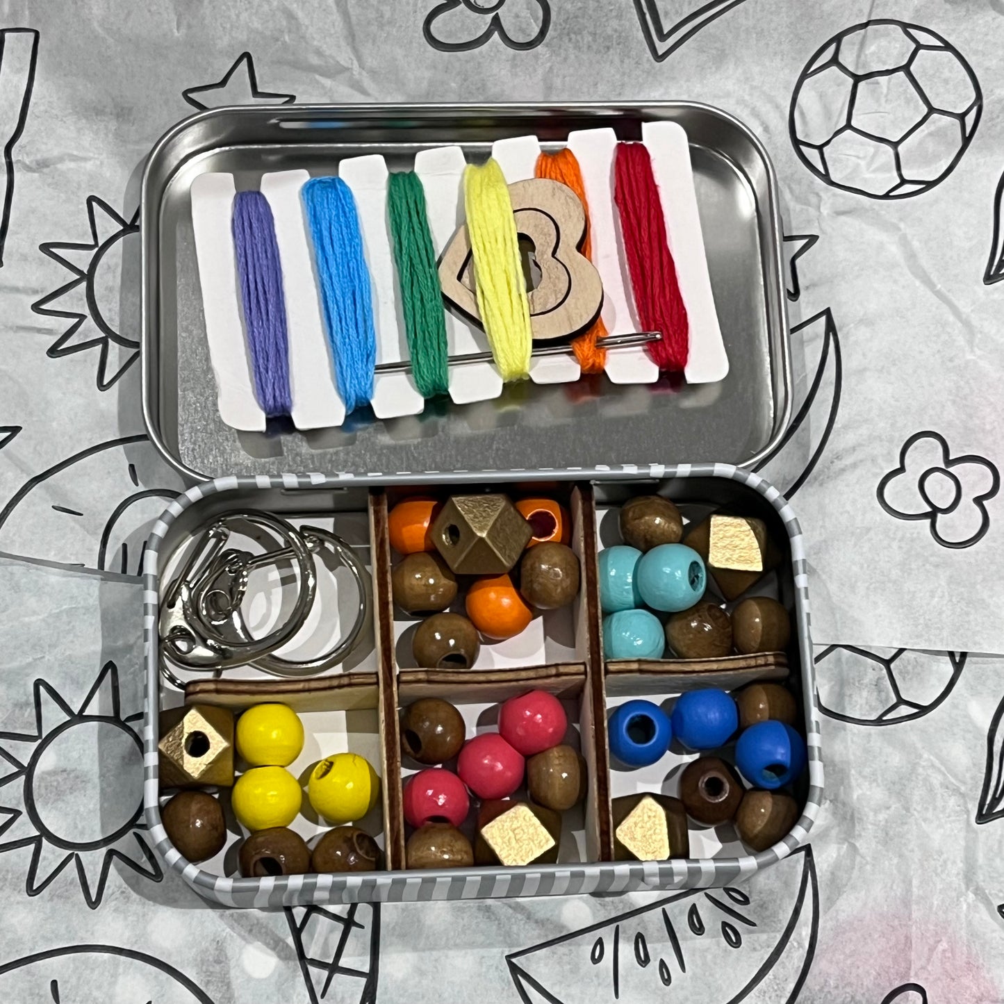 Plastic-free kids keyring kit with wooden beads, heart charms, coloured threads, and keyring fobs, box open