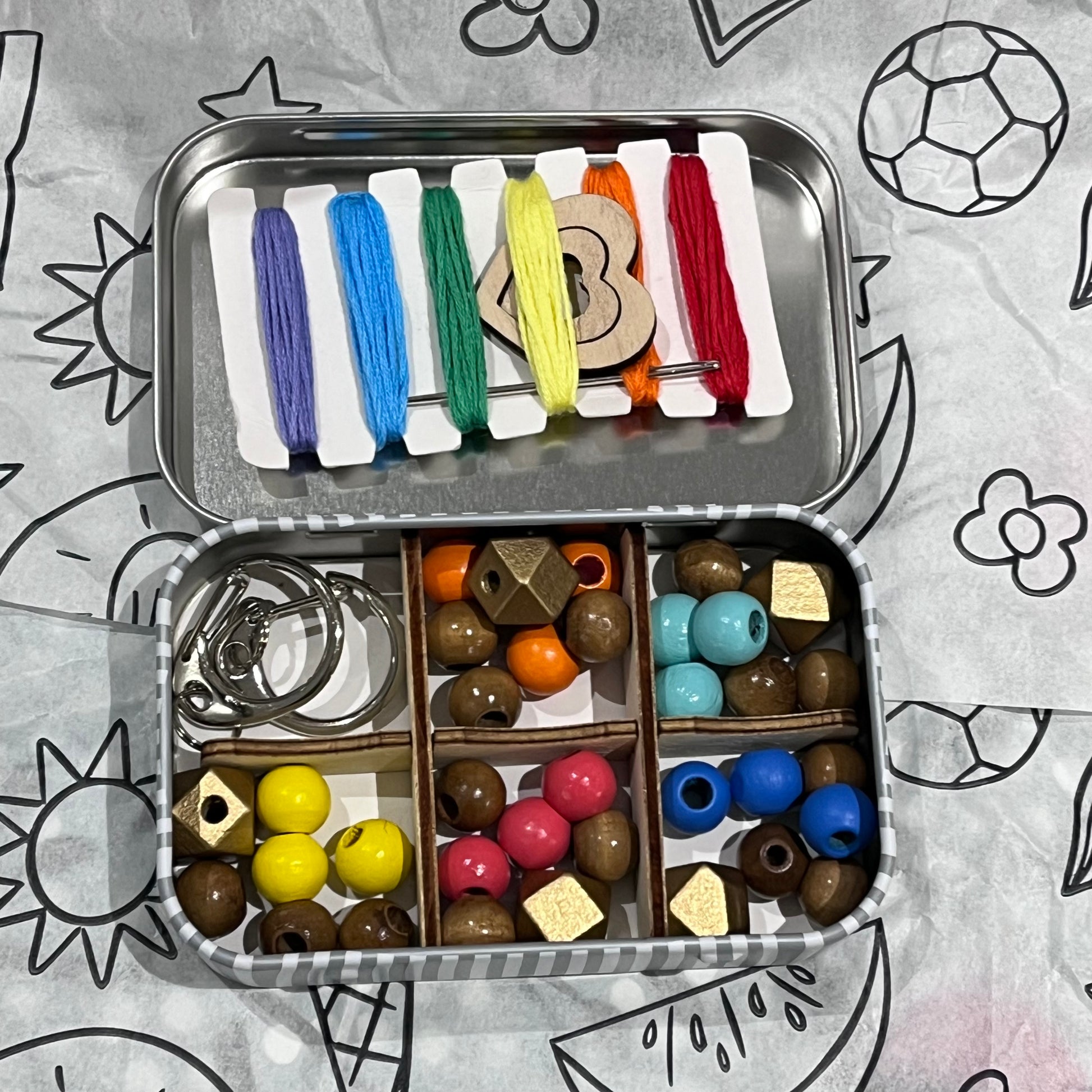 Plastic-free kids keyring kit with wooden beads, heart charms, coloured threads, and keyring fobs, box open