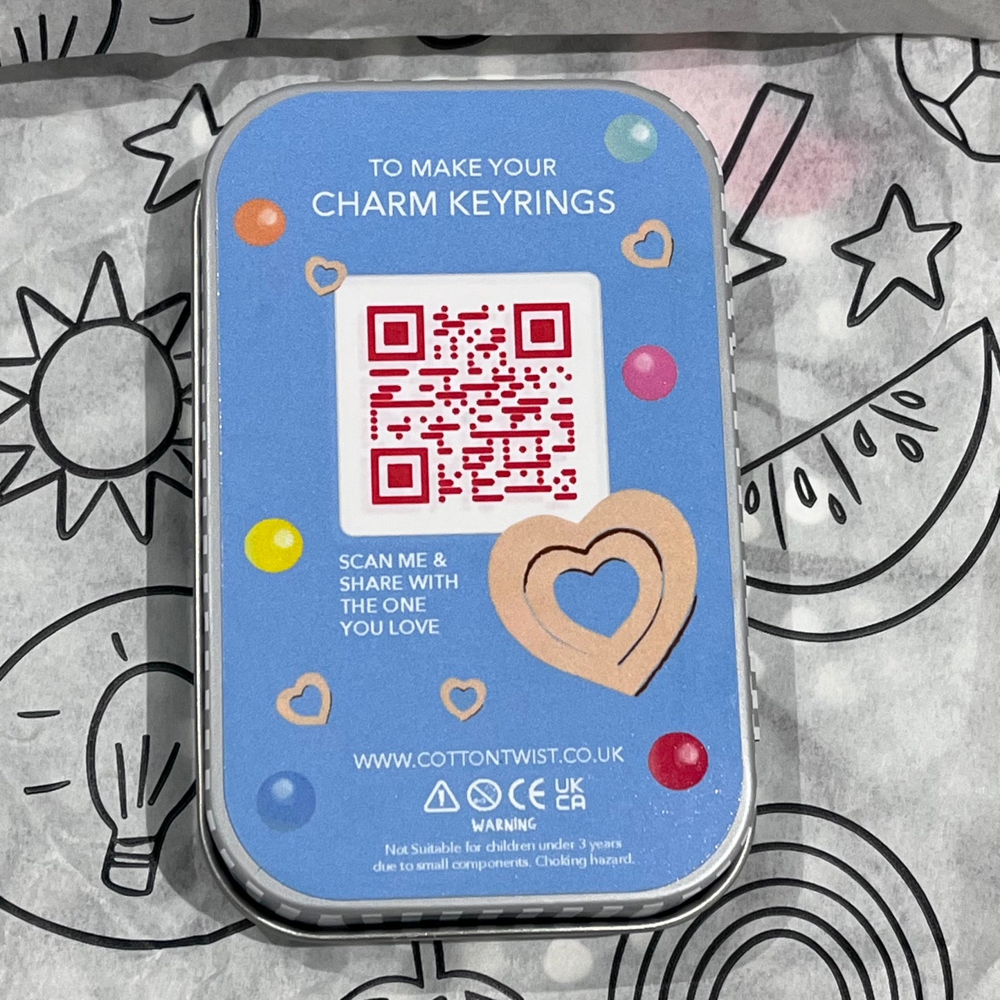 Plastic-free kids keyring kit with wooden beads, heart charms, coloured threads, and keyring fobs, back of box