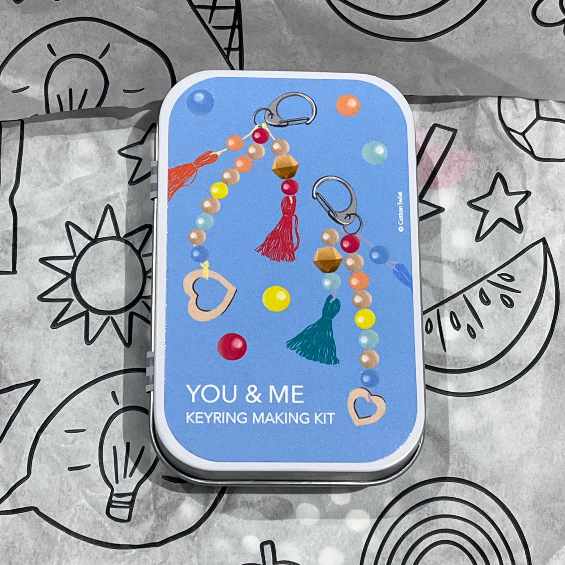 Plastic-free kids keyring kit with wooden beads, heart charms, coloured threads, and keyring fobs, box closed