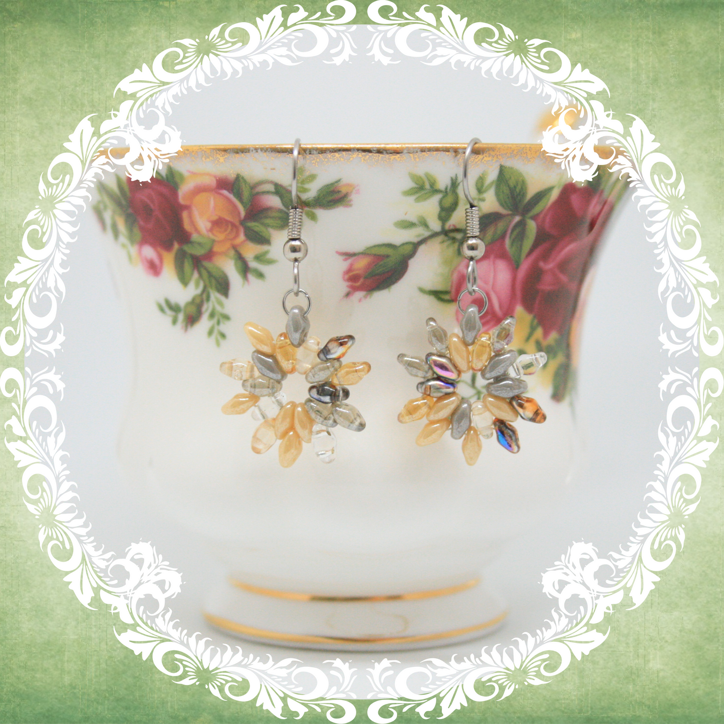 Handmade woven orange, silver and clear flower earrings on stainless steel ear wires shown on vintage floral teacup