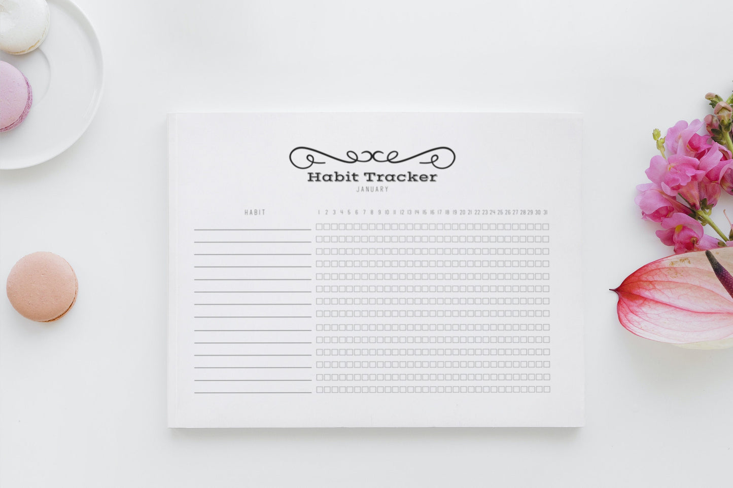 Flat lay of printable habit tracker on white table