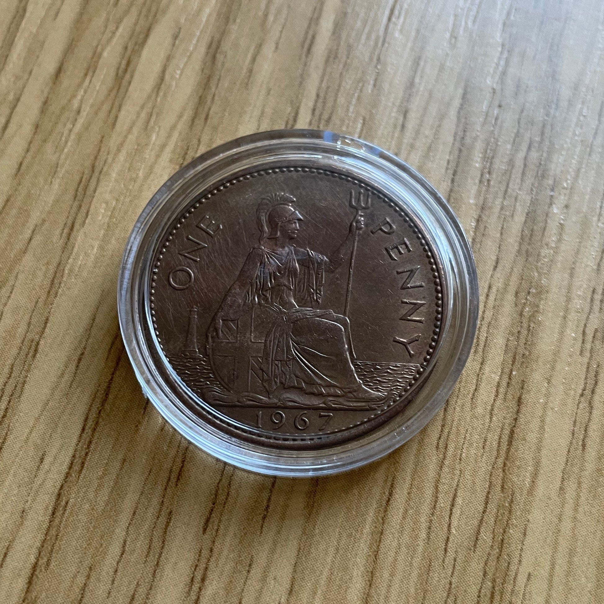 Queen Elizabeth II copper one penny coin in protective capsule, obverse
