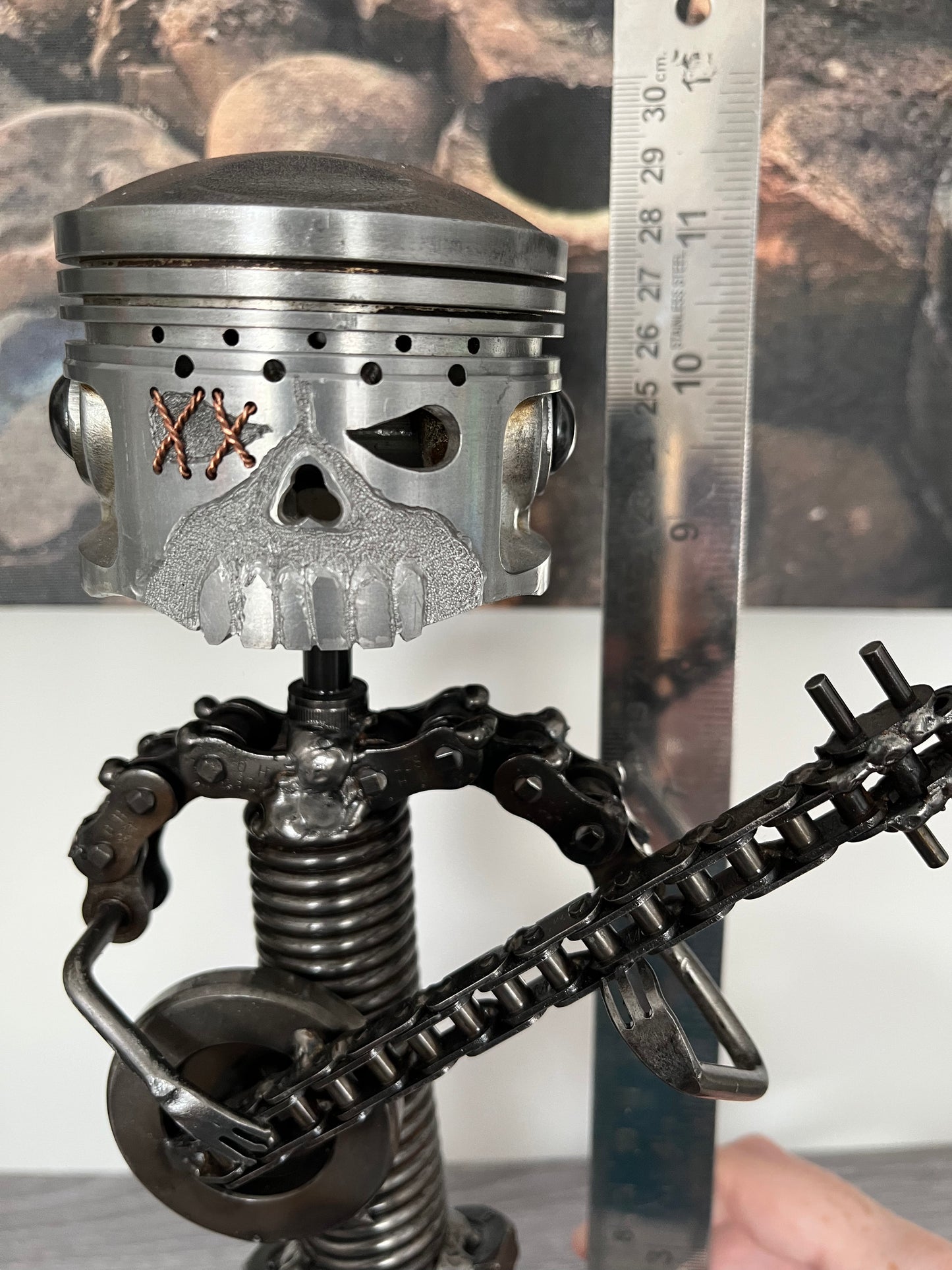 Close-up of scrap metal banjo player sculpture made from nuts, bolts, and automotive parts — steampunk-inspired handmade art piece for banjo enthusiasts and collectors, showing height measurement.