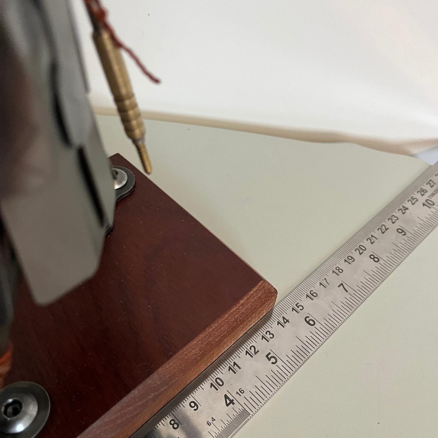 Samurai warrior sculpture made from a piston head, featuring copper and steel armor, a wooden base, and a sword. Showing length measurement of base.