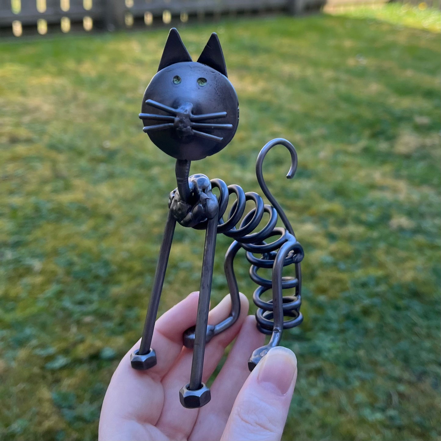 Handcrafted scrap metal cat sculpture made from springs — quirky industrial home decor or unique gift for cat lovers and upcycled art fans.