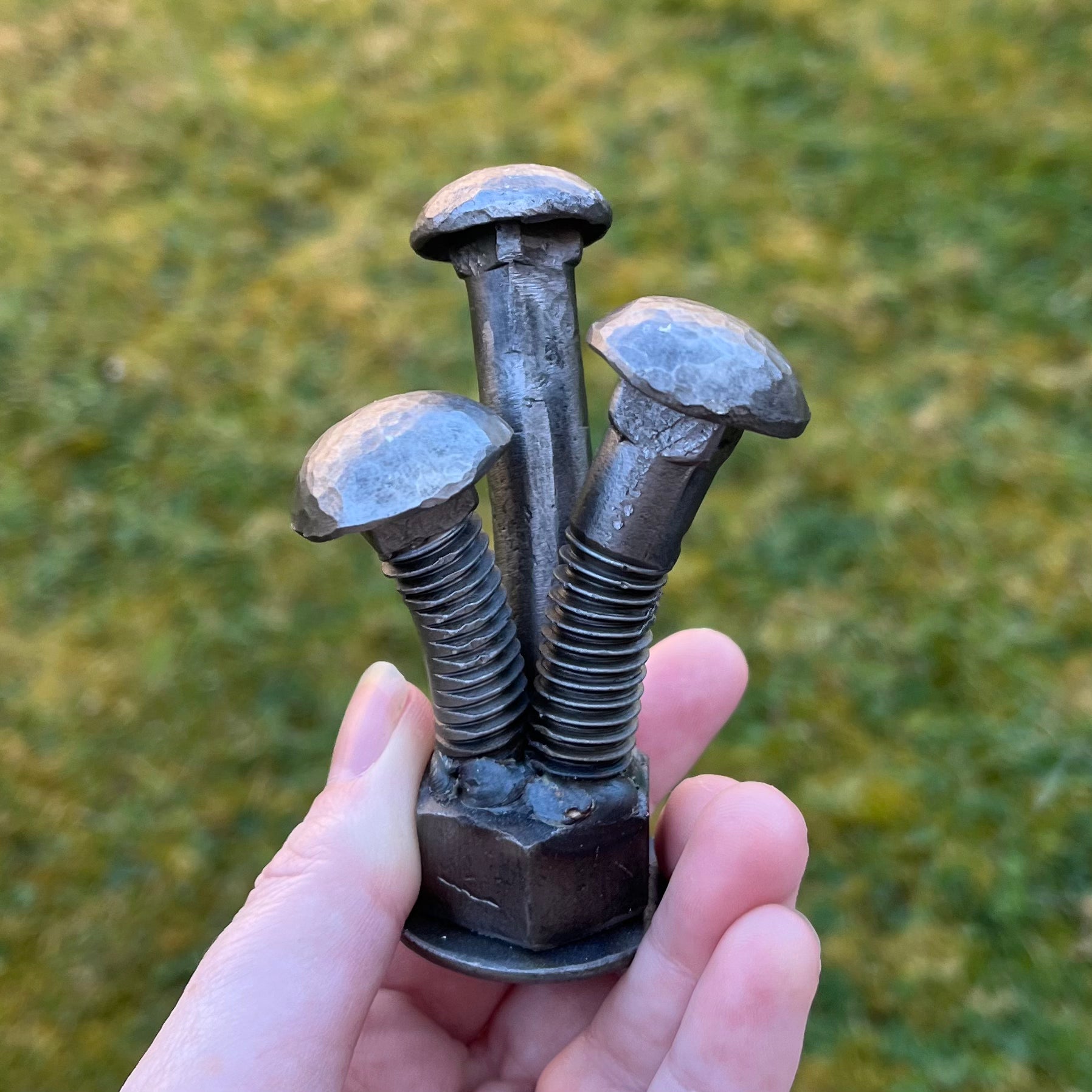 Scrap metal mushroom sculpture handcrafted from screws and nuts. Industrial-style art piece perfect for garden decor, rustic home accents, or unique gifts for nature and upcycled art lovers.