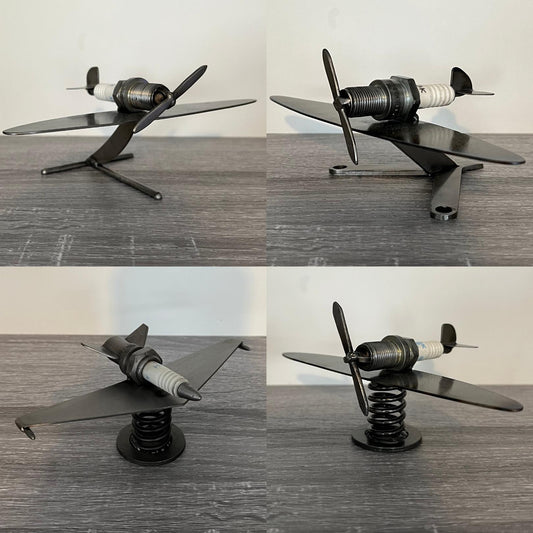 Set of four handmade scrap metal airplane sculptures crafted from recycled spark plugs and steel parts, displayed on a grey wood surface — unique aviation-themed industrial decor for collectors and gift ideas for pilots or mechanics.
