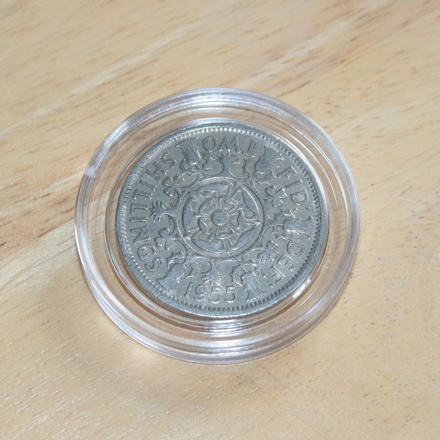 Queen Elizabeth II silver two shilling coin in protective capsule, reverse 1955