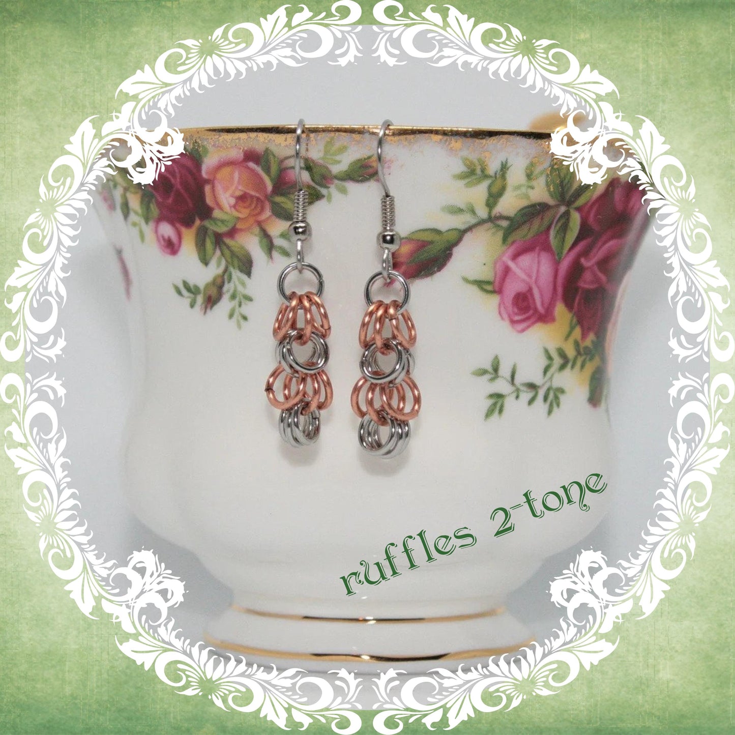 Handmade stainless steel and copper chainmail dangle earrings shown on vintage floral teacup, modern medieval fashion accessory, ruffles design