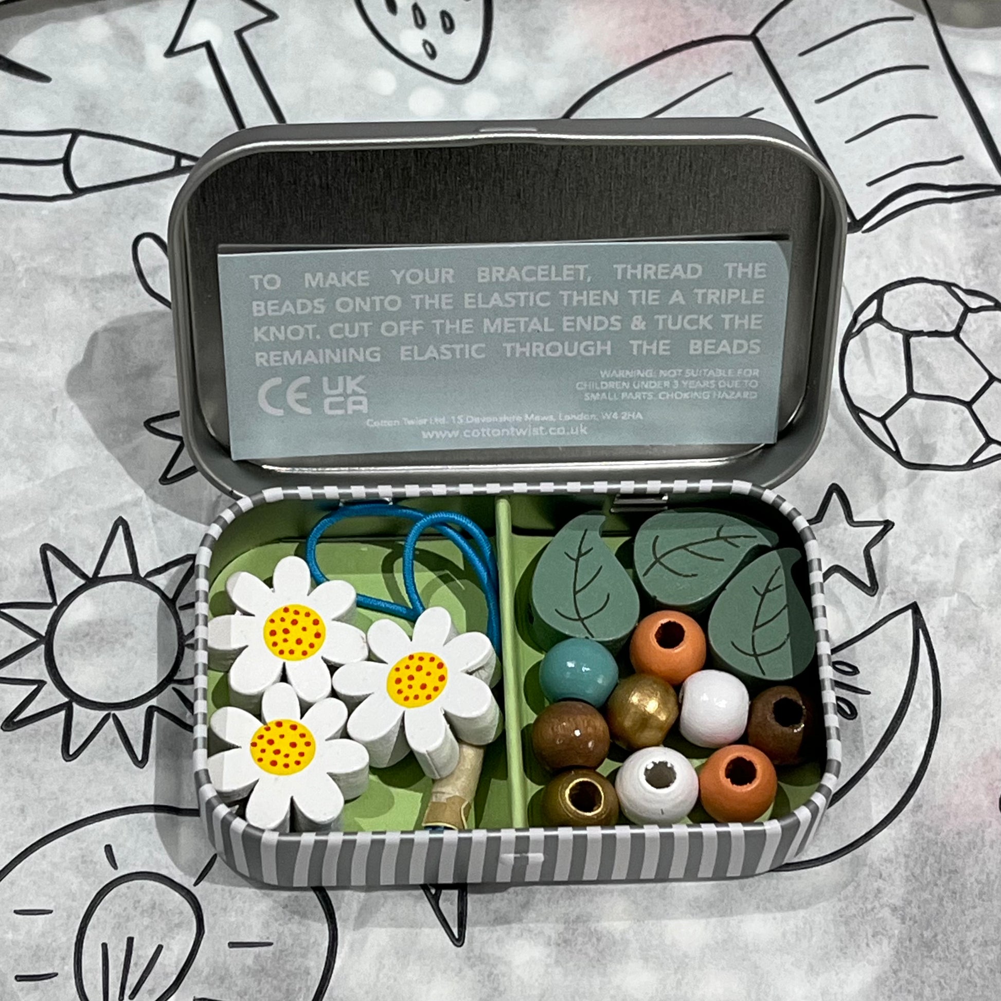 Plastic-free kids daisy chain bracelet kit with wooden daisy and leaf beads, round beads, and elastic, box open