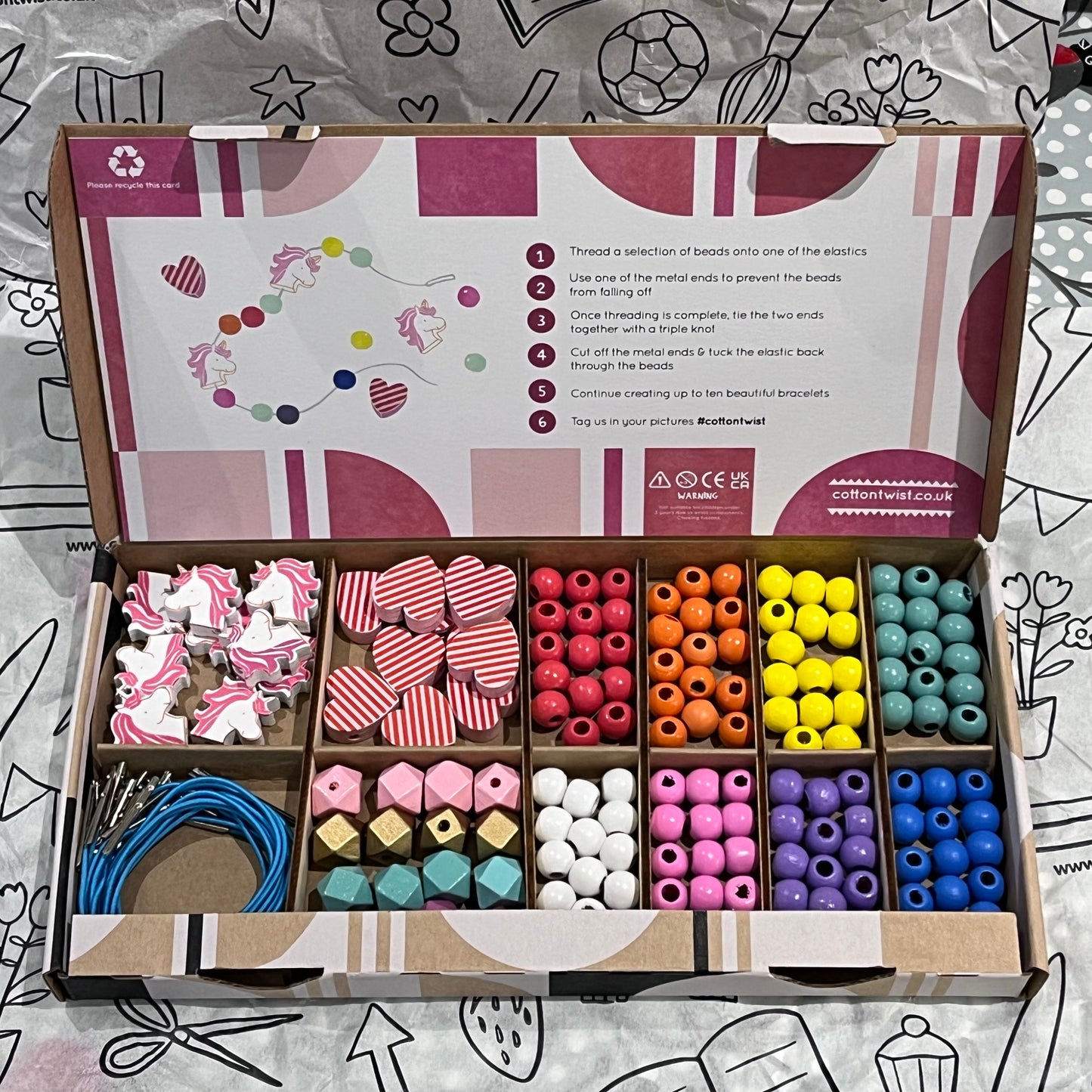 Plastic-free kids unicorn and heart bracelet kit with wooden beads, and elastic, box open